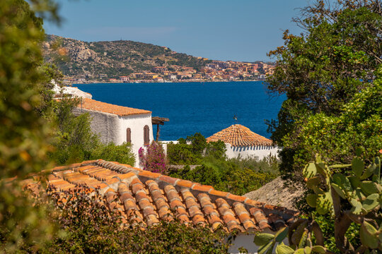 View of La Maddalena and terracotta rooftops and whitewashed villas of Porto Rafael, Sardinia