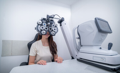 Woman optical shop customer doing eyesight measurement with optical phoropter check eye distance...