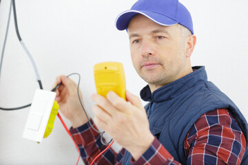 male measures voltage with an ammeter
