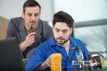 apprentice and teacher during engineering test