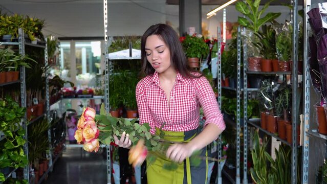 Funny woman florist prick with flowers