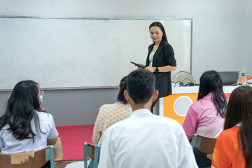 College female teacher teaching students in the classroom