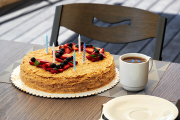 Sweet homemade cake with a tea cup on the table. Kids 5 year birthday celebration