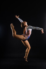 Fashion girl ballet dancer. Sport gymnastics studio shot on white and black background