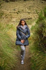 vertical photo of a latin woman in the andes mountains in la paz bolivia