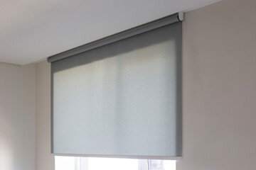 Roller blinds automatic close-up on the window. Selective focus. Motorized shades. Gray color...