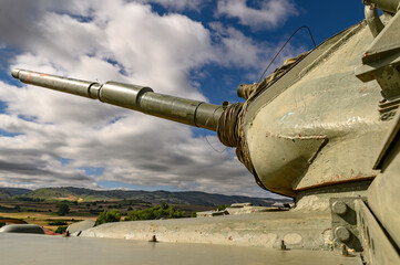 close-up of the cannon in the turret of a tank, armored car M60 patton, of the disabled Spanish army, green exposed in Rojas, a small town in Burgos, in the middle of the field on a mound, on the gras © Javier Peribáñez