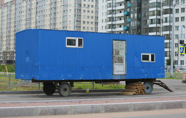 Blue trailer-a shed for workers on the street, Soyuzny Prospekt, Saint Petersburg, Russia, July 07, 2023