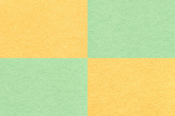 Fototapeta premium Texture of craft light green and yellow paper background with cells pattern, macro. Vintage dense kraft mint cardboard.