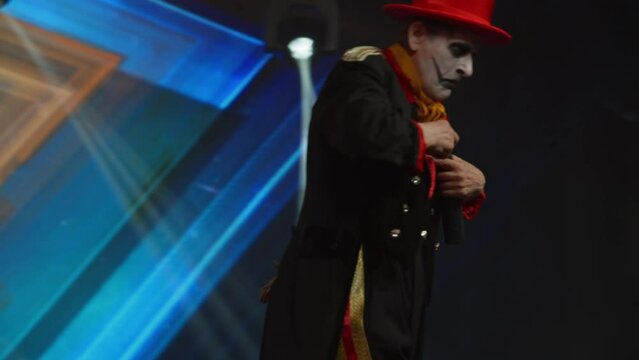 Creepy clown mime showing magic tricks on stage during talent show audition. Broadcast television style TV entertainment program 
