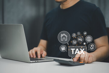 Businessman using laptop for online income tax return form. Symbolic of financial research, government taxes, and tax return calculation. Also alludes to tax and VAT concepts.