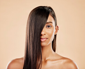 Hair care, cosmetics and portrait of a woman on a studio background with salon treatment. Beauty, healthy and headshot of an Indian model or girl showing shampoo results isolated on a backdrop