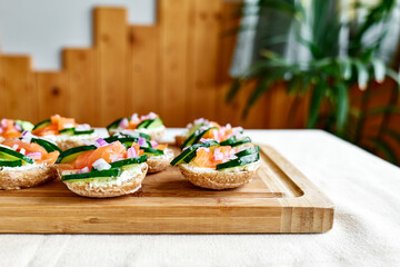 Open sandwiches with smoked salmon, cream cheese and sliced cucumber. Summer bruschetta appetizer ideas. Healthy eating.