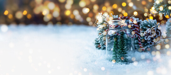 Christmas Winter background with Christmas tree in snow and magic bokeh lights - xmas panorama,...