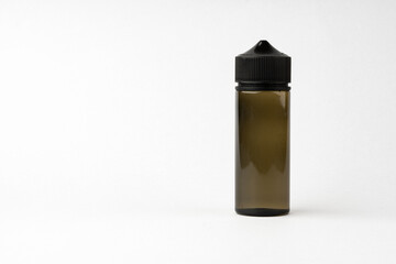 Small black glass dropper bottle front view on gray background