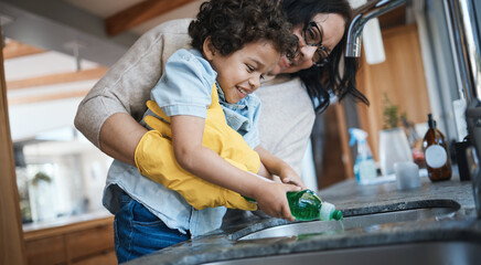Washing, dishes and mother with child in kitchen for learning housework, teaching and helping with chores. Housekeeping, happy family and mom and boy with soap for cleaning, hygiene and development