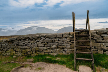 Ladder style over a dry stone wall on the walk path in Mourne mountains. Ireland