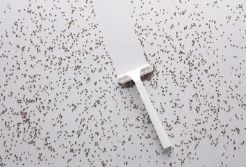 Beauty concept. Razor with chia seeds on gray background