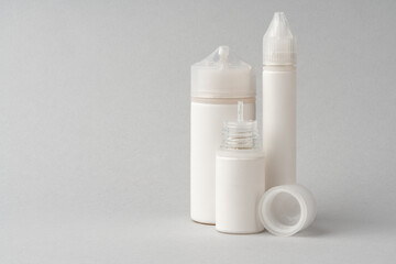 Refill liquid for electronic cigarettes on gray background