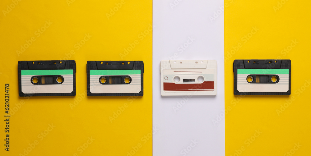 Poster outdated technologies. retro audio cassettes on a yellow-white background. back to the 80s. minimali