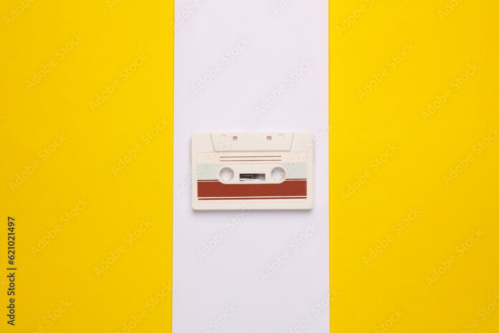 Poster outdated technologies. retro audio cassette on a yellow-white background. back to the 80s. minimalis
