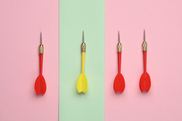Darts on a pastel background. Minimalism business concept