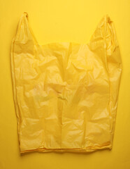 Obraz premium Yellow cellophane bag on a yellow background