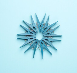 Blue plastic clothespins on a blue background