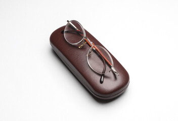 Eyeglasses with a case on white background