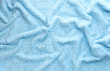 Crumpled blue fleecy fabric closeup texture