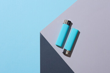 Lighters on the corner of gray cube. Optical geometric illusion. Creative layout. Minimalism. Beauty concept