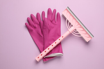 Window cleaning mop with gloves on pink background. Top view