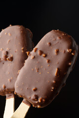 Chocolate cake pops ice cream on black background