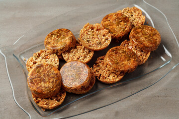 Crunchy homemade cookies on glass plate on gray background