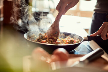 Young woman cooking in the kitchen