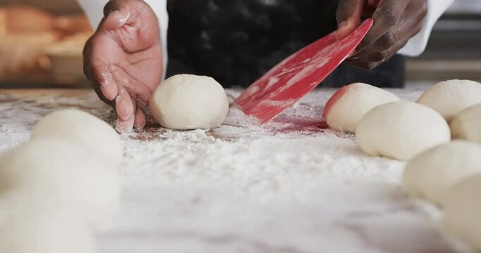 African American Male Baker Working In Bakery Kitchen, Making Bread Rolls Dough In Slow Motion