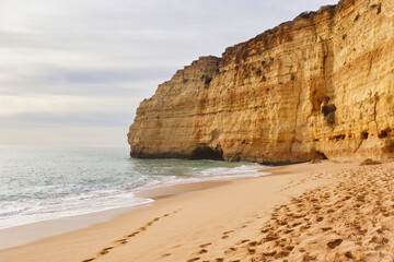 Sandy beach with limestone cliff on a winter day in southern Portugal.