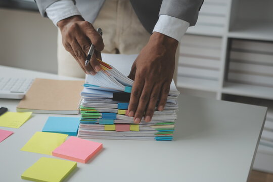 Financial analysts analyze business financial reports on a digital tablet planning investment project during a discussion at a meeting of corporate showing the results of their successful teamwork.