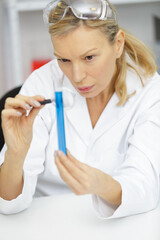 female chemist wearing safety glasses in a lab