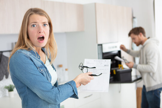 woman shocked and surprised with her electricity bills