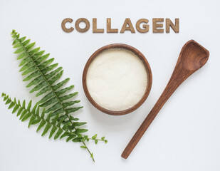Collagen Powder in Wooden Bowl and Fern Fronds 