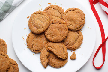 Freshly baked ginger sparkle molasses cookies on a kitchen plate.