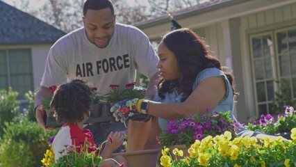 Veteran father brings flowers to his family to plant in the garden
