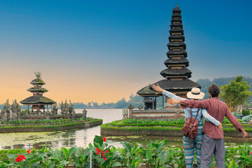 Couple spending time at ulun datu bratan temple in Bali. Wanderlust lifestyle exotic travel concept