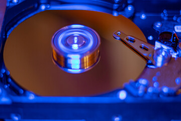Fototapeta na wymiar Computer hard drive without protective cover. Close up of hard disk with abstract reflection. Opened hard drive from the computer hdd with mirror effects Part of computer pc. Soft selective focus