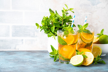 Fototapeta premium Iced tea. Summer drink with lemon, lime, mint and ice. Cold lemonade.