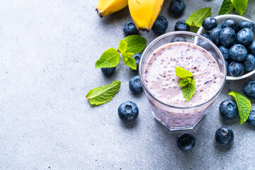 Smoothie or milkshake with fresh blueberry and banana. Healthy diet snack.