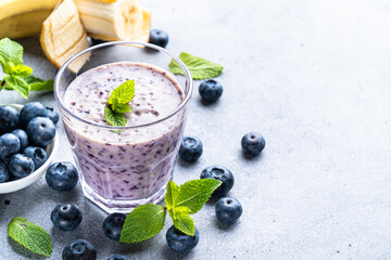 Smoothie or milkshake with fresh blueberry and banana. Healthy diet snack.