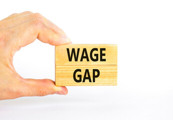 Wage gap symbol. Concept words Wage gap on wooden blocks on a beautiful white table white background. Businessman hand. Business, support and wage gap concept. Copy space.
