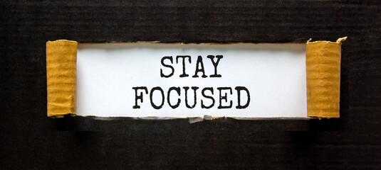 Stay focused symbol. Concept words Stay focused on beautiful white paper on a beautiful black background. Business, support, motivation, psychological stay focused concept. Copy space